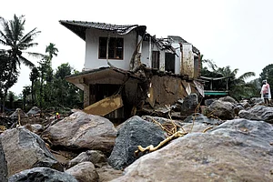 PTI : A rescuer stands next to a damaged houses on the 2nd day of operation following landslide in Wayanad district, Kerala, Wednesday, July 31, 2024